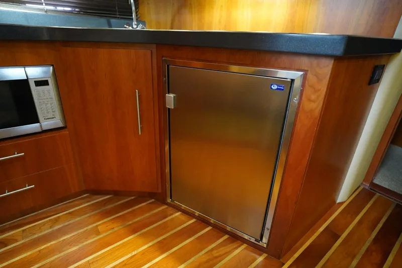  Yacht Photos Pics Luxurious kitchen interior of 2012 Regal 42 Sport Coupe yacht with stainless steel appliances.