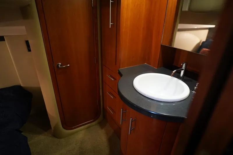  Yacht Photos Pics Luxurious bathroom interior of 2012 Regal 42 Sport Coupe yacht with wooden cabinetry.