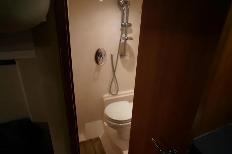  Yacht Photos Pics Bathroom interior of 2012 Regal 42 Sport Coupe yacht, featuring shower and toilet.