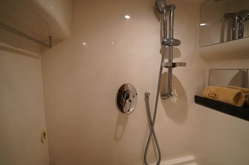  Yacht Photos Pics Shower area in 2012 Regal 42 Sport Coupe yacht with chrome fixtures and towel.