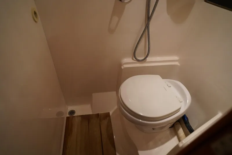  Yacht Photos Pics Bathroom interior of 2012 Regal 42 Sport Coupe yacht, featuring a compact toilet and shower.