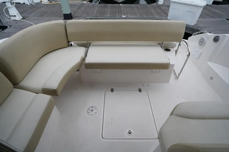  Yacht Photos Pics 2012 Regal 42 Sport Coupe boat seating area with beige cushions and white deck.