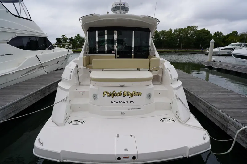  Yacht Photos Pics 2012 Regal 42 Sport Coupe docked at marina, rear view with seating area.