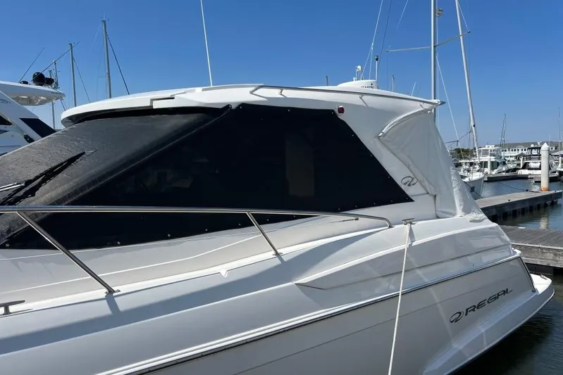  Yacht Photos Pics 2012 Regal 42 Sport Coupe yacht docked at marina under clear blue sky.