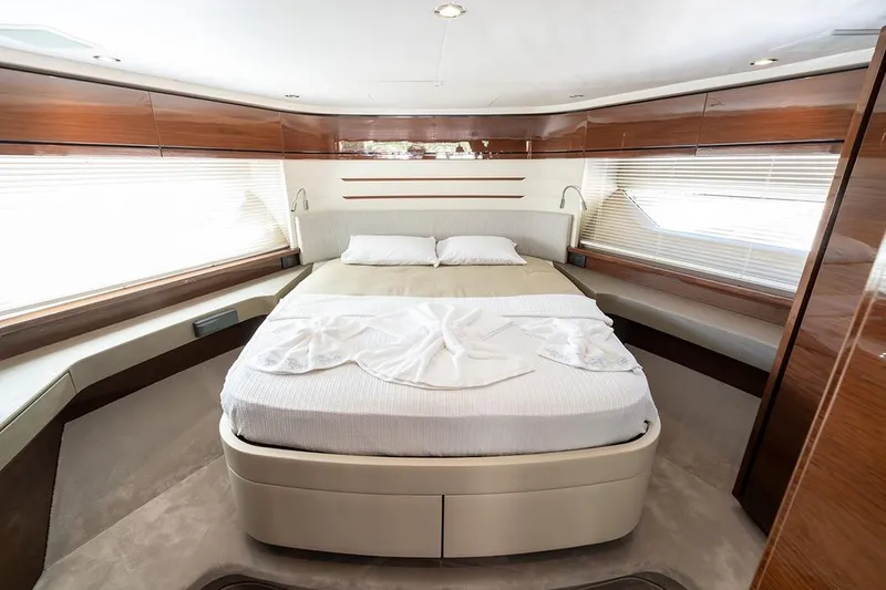 Daphne Yacht Photos Pics Luxurious bedroom interior of 2018 Princess 68 yacht with elegant wood finishes.