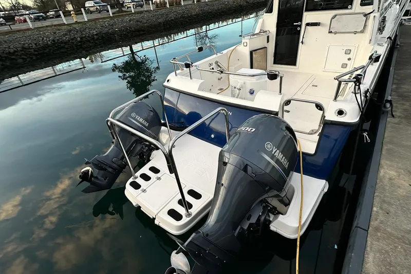  Yacht Photos Pics 2019 Aspen C107 boat with dual Yamaha outboard motors docked on calm water.