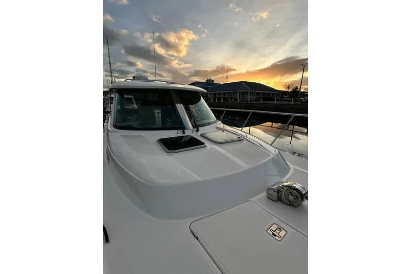  Yacht Photos Pics 2019 Aspen C107 boat at sunset, docked with a scenic sky backdrop.