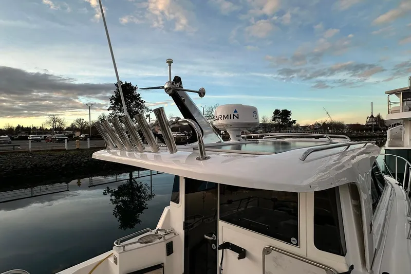  Yacht Photos Pics 2019 Aspen C107 boat with radar and rod holders at sunset by the water.