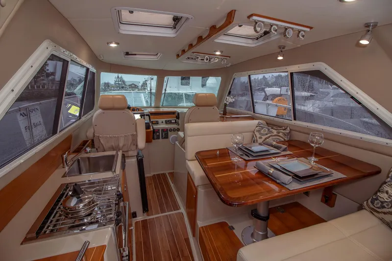  Yacht Photos Pics Luxurious interior of 2019 Aspen C107 yacht with dining area and helm station.