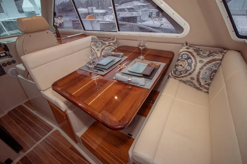  Yacht Photos Pics Luxurious interior of 2019 Aspen C107 yacht with elegant dining setup and plush seating.