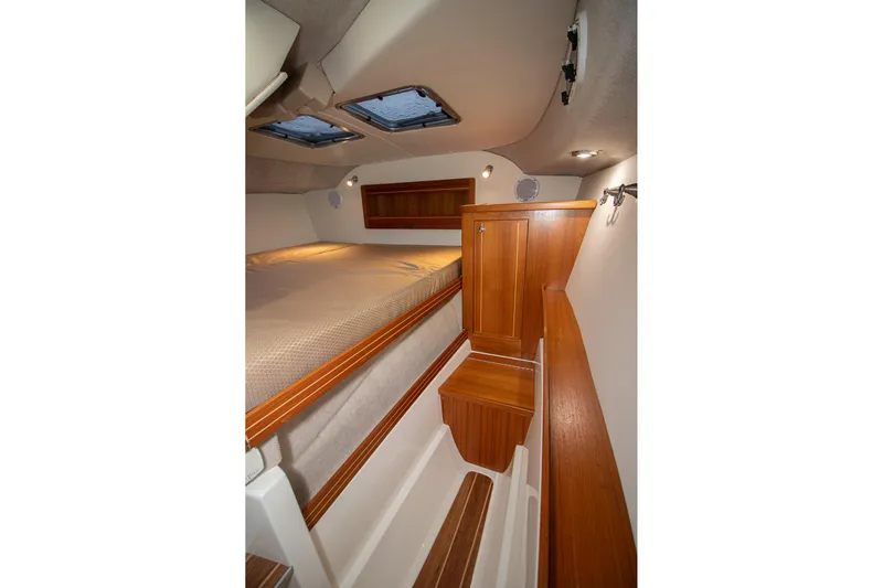  Yacht Photos Pics 2019 Aspen C107 boat interior with wood finish and cozy sleeping area.