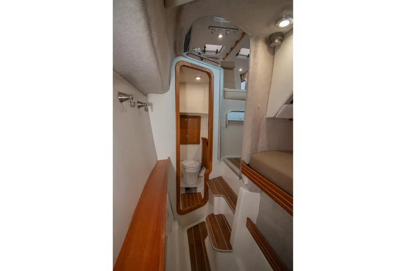  Yacht Photos Pics Interior of 2019 Aspen C107 boat featuring compact bathroom and wooden accents.