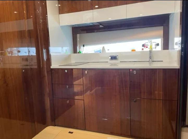  Yacht Photos Pics Luxurious kitchen interior of 2021 Fairline Targa 45 Open yacht with sleek wood cabinetry.