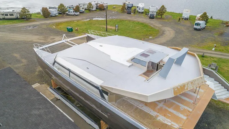 Mai Cat Yacht Photos Pics 2025 Catamaran Bloomfield 86 Motorsailor under construction in a coastal area.