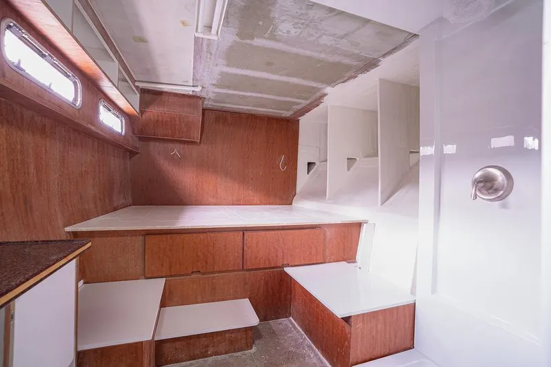 Mai Cat Yacht Photos Pics Interior of 2025 Catamaran Bloomfield 86 Motorsailor with wooden cabinetry and modern design.