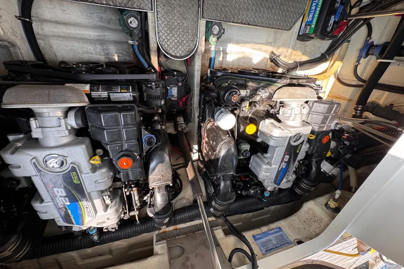 Love Shact Yacht Photos Pics Engine compartment of a 2012 Formula 37 PC boat, showcasing dual engines and mechanical components.
