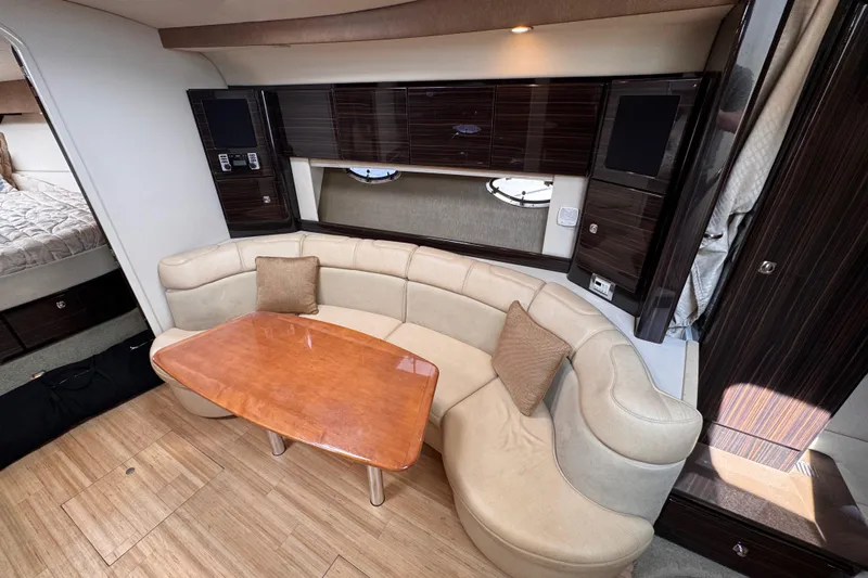 Love Shact Yacht Photos Pics Luxurious interior of a 2012 Formula 37 PC yacht with elegant seating and wooden table.