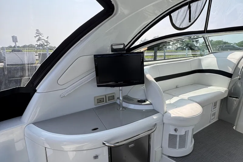 Love Shact Yacht Photos Pics Interior of a 2012 Formula 37 PC yacht with seating and a mounted TV.