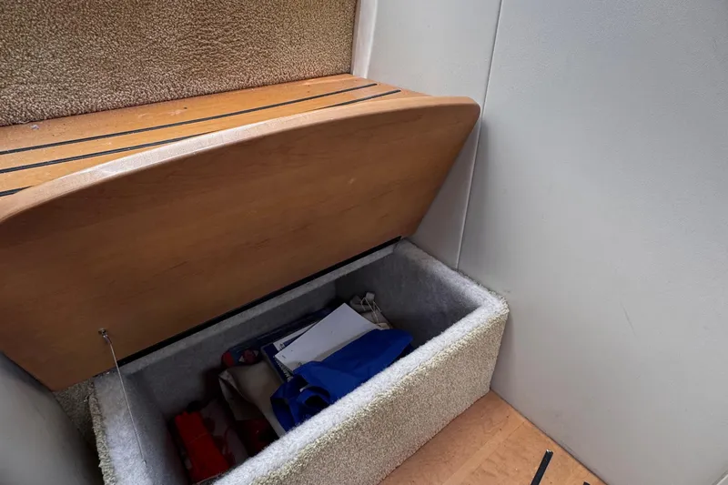 Love Shact Yacht Photos Pics Storage compartment in 2012 Formula 37 PC boat with various items inside.