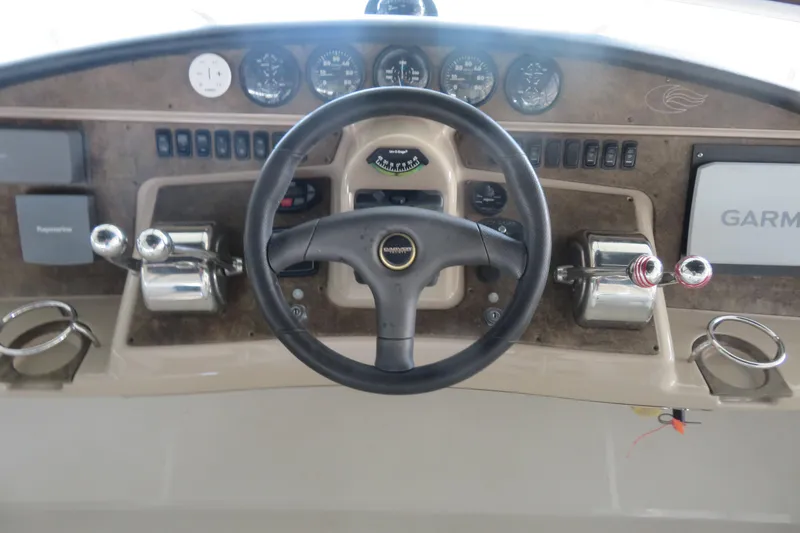 38 Special Yacht Photos Pics 2006 Carver 38 Super Sport helm with steering wheel, gauges, and navigation equipment.