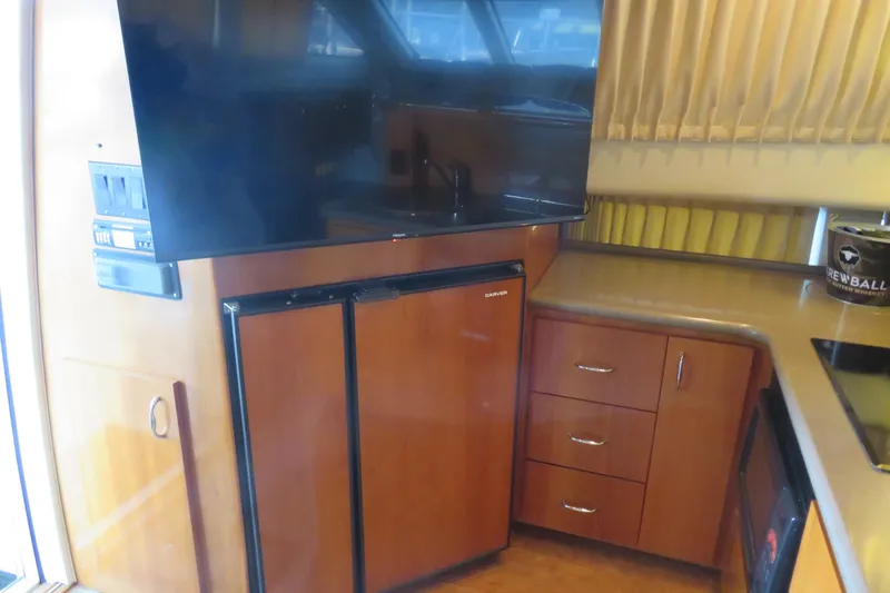 38 Special Yacht Photos Pics Interior of 2006 Carver 38 Super Sport yacht with kitchenette and TV.