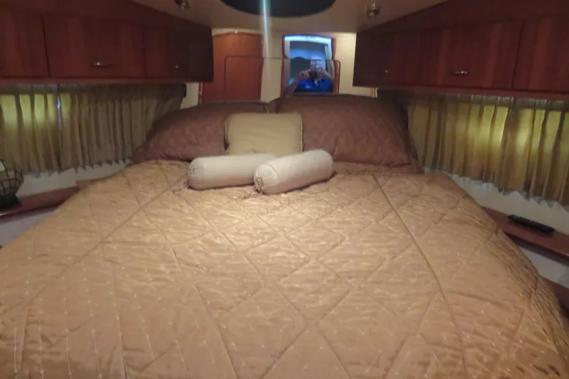 38 Special Yacht Photos Pics Interior cabin of 2006 Carver 38 Super Sport with cozy bed and wooden cabinets.