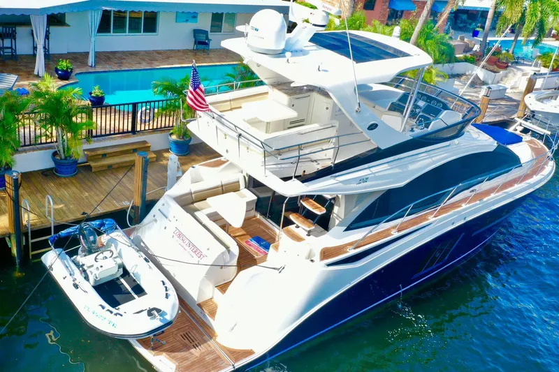  Yacht Photos Pics 2015 Sea Ray 510 Fly yacht docked by a poolside, featuring sleek design and luxury amenities.