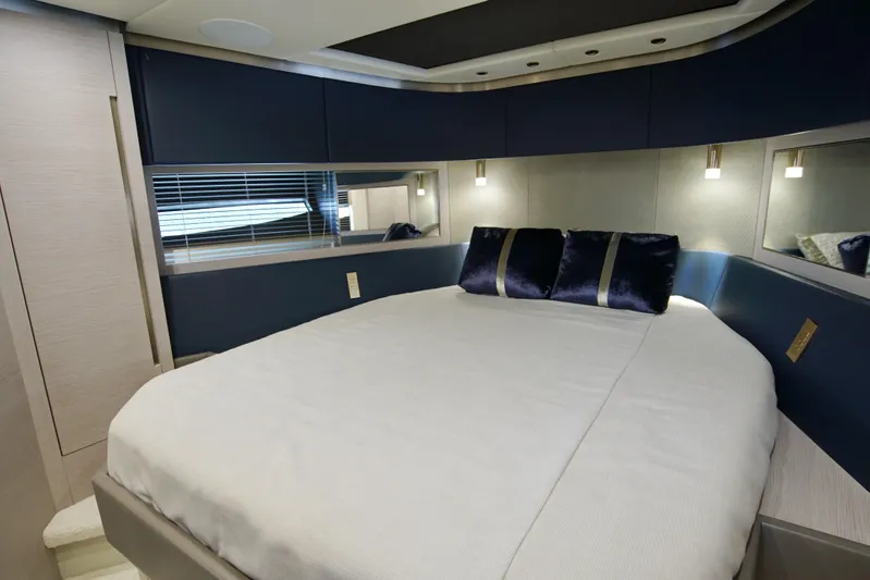  Yacht Photos Pics Luxurious bedroom interior of 2024 Uniesse HTC5P yacht with modern design and elegant bedding.