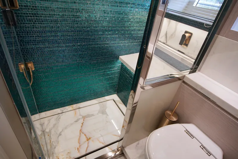 Yacht Photos Pics Luxurious bathroom in 2024 Uniesse HTC5P yacht with marble and mosaic tile design.