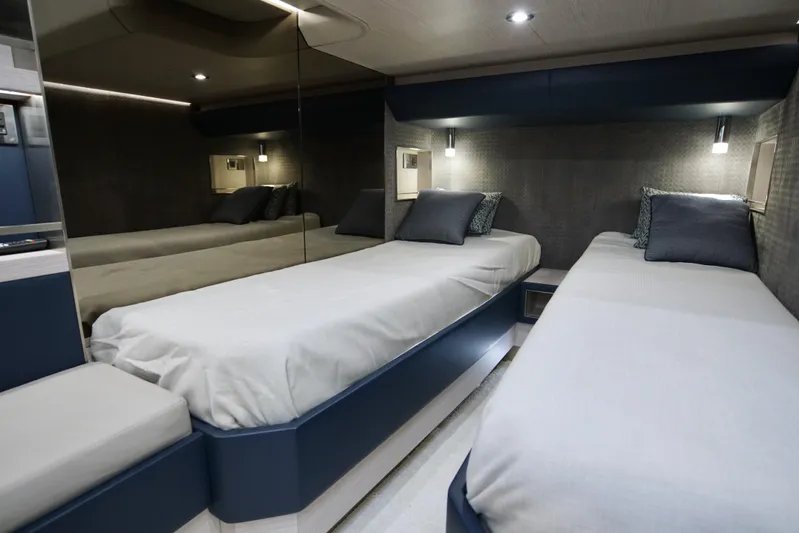  Yacht Photos Pics 2024 Uniesse HTC5P yacht interior with twin beds and modern lighting.