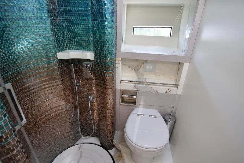  Yacht Photos Pics Luxurious bathroom in 2024 Uniesse HTC5P yacht with mosaic shower and modern fixtures.