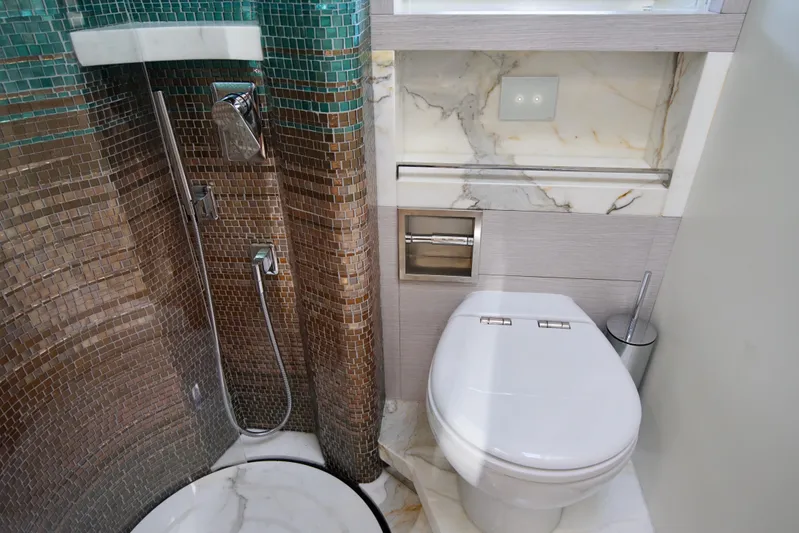  Yacht Photos Pics Luxurious bathroom in 2024 Uniesse HTC5P yacht with modern shower and toilet.