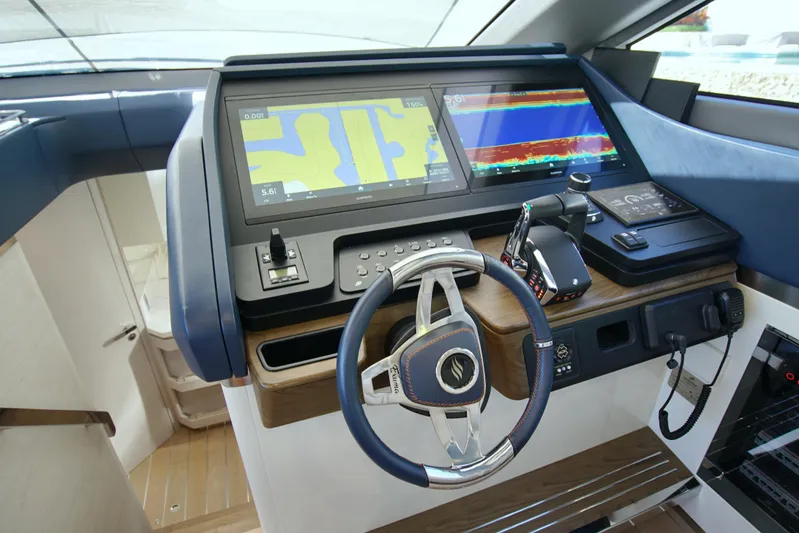  Yacht Photos Pics 2024 Uniesse HTC5P yacht helm with advanced navigation displays and controls.