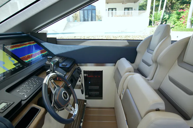  Yacht Photos Pics 2024 Uniesse HTC5P yacht cockpit with modern navigation system and luxurious seating.