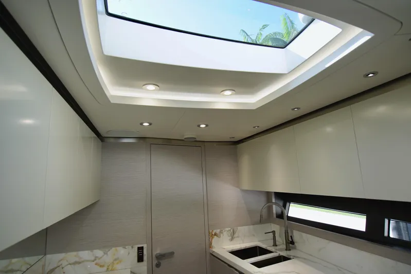  Yacht Photos Pics Luxurious interior of 2024 Uniesse HTC5P yacht with modern kitchen and skylight.