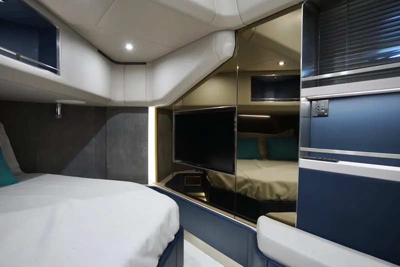  Yacht Photos Pics Luxurious interior of 2024 Uniesse HTC5P yacht with modern design and cozy bedding.