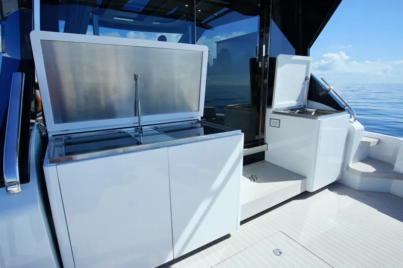  Yacht Photos Pics 2024 Uniesse HTC5P yacht deck with open storage compartments, sleek design, and ocean view.