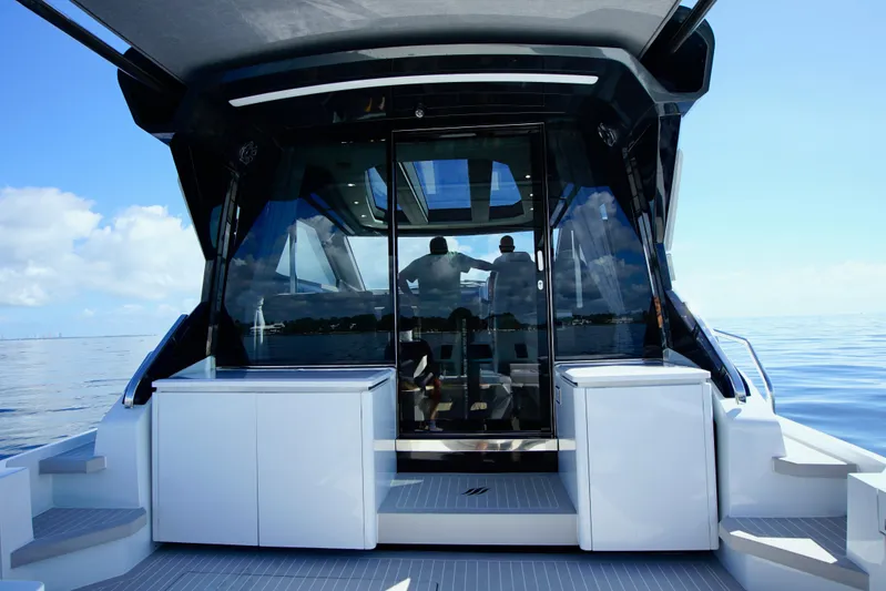  Yacht Photos Pics 2024 Uniesse HTC5P yacht, rear view, sleek design, open sea, modern luxury vessel.