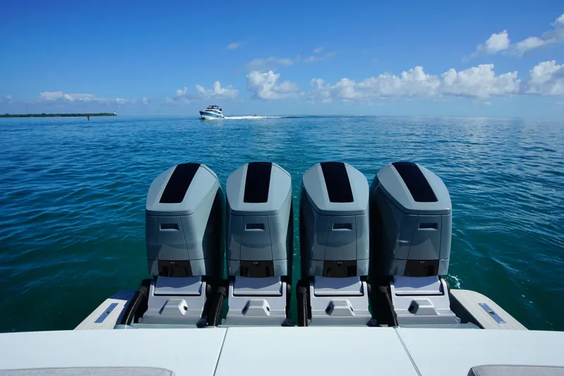  Yacht Photos Pics 2024 Uniesse HTC5P boat with four powerful outboard engines on open water.