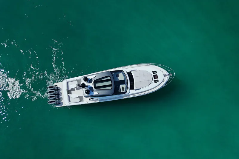  Yacht Photos Pics Aerial view of 2024 Uniesse HTC5P yacht cruising on turquoise water.