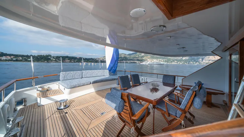 Bluemar II Yacht Photos Pics 1978 Feadship Classic yacht deck with seating and dining area.