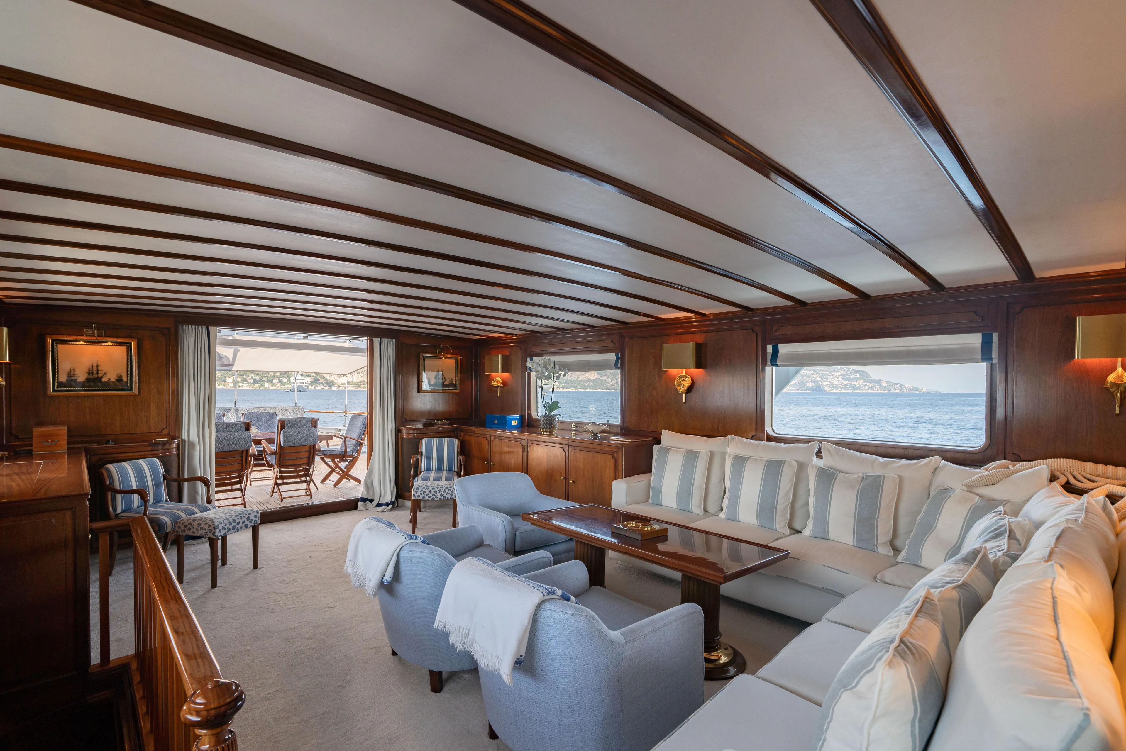 Bluemar II Yacht Photos Pics Luxurious interior of a 1978 Feadship Classic yacht with elegant seating and ocean views.