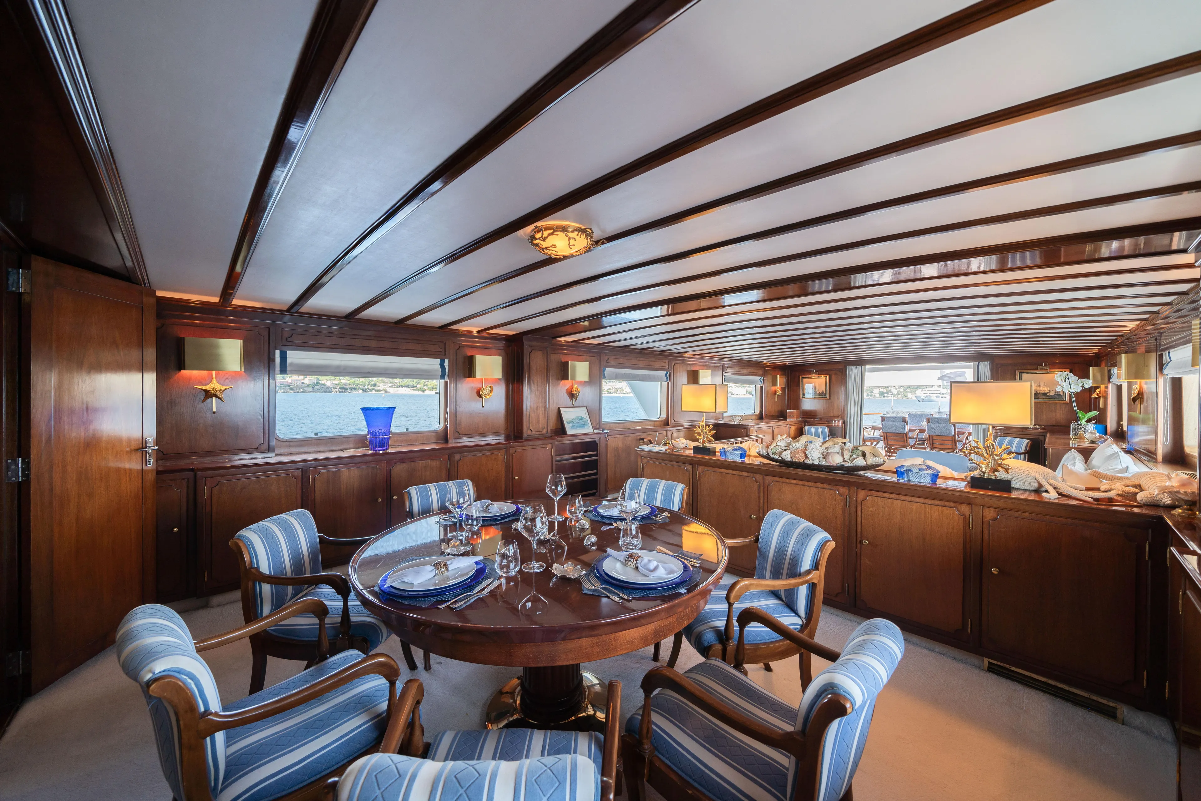 Bluemar II Yacht Photos Pics Luxurious dining area on a 1978 Feadship Classic yacht with elegant wooden interiors.