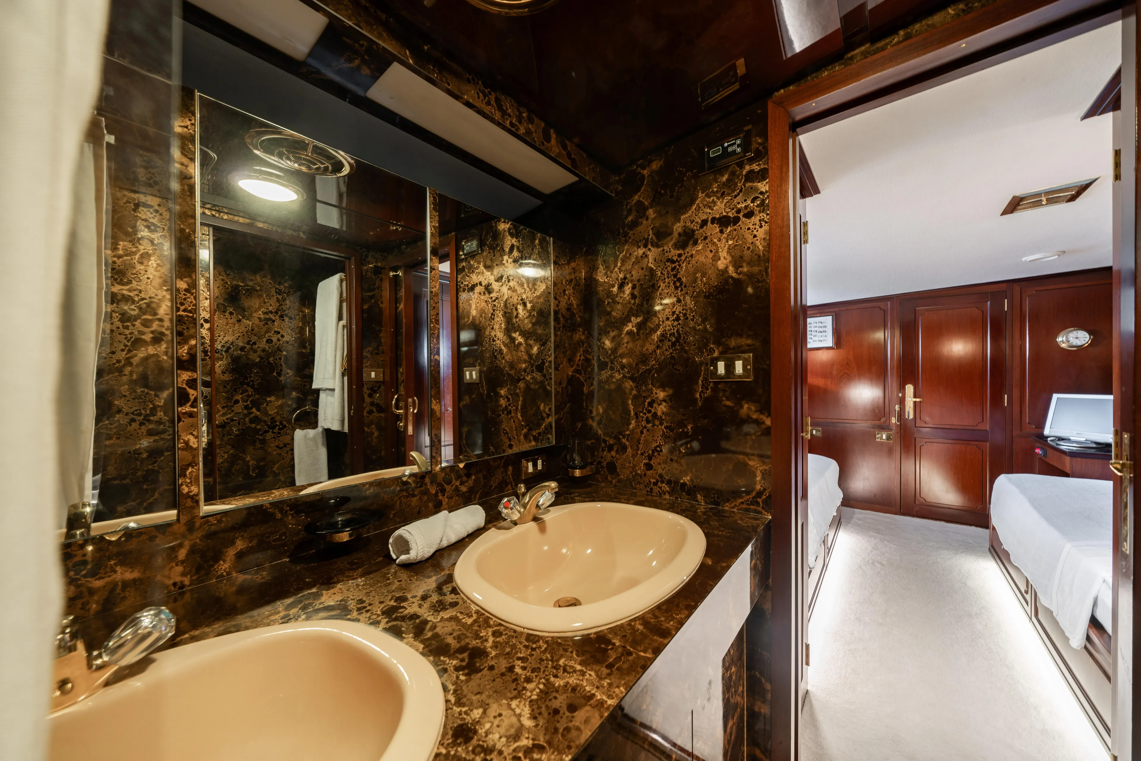 Bluemar II Yacht Photos Pics Luxurious bathroom on a 1978 Feadship Classic yacht with marble countertops and dual sinks.