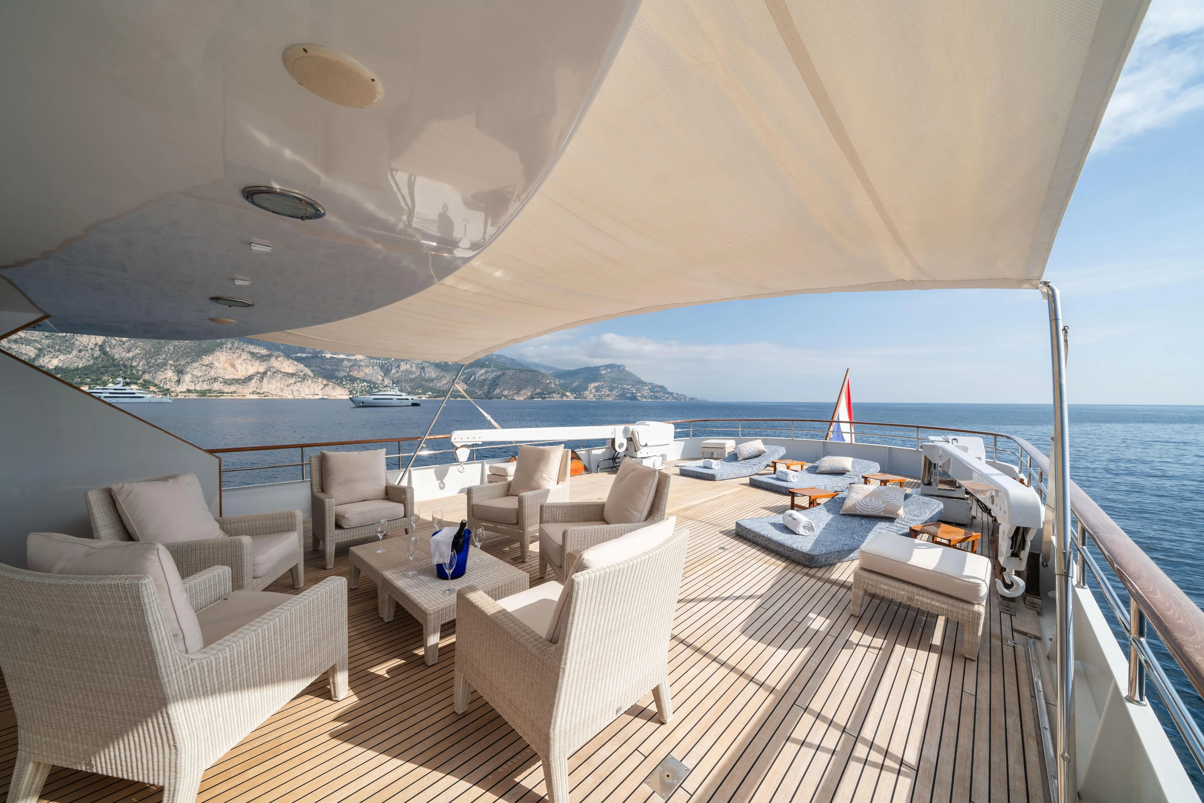 Bluemar II Yacht Photos Pics Luxurious deck of 1978 Feadship Classic yacht with seating and ocean view.