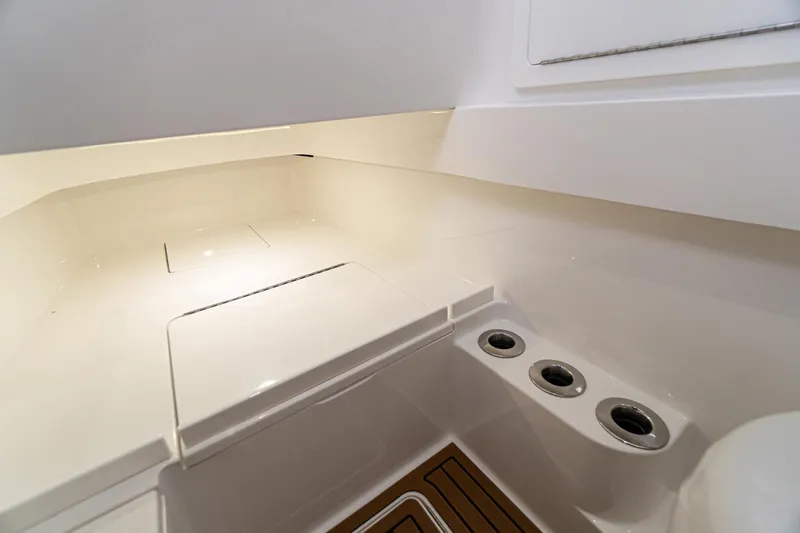 Archie Yacht Photos Pics 2021 Valhalla Boatworks V-33 interior with sleek white surfaces and storage compartments.