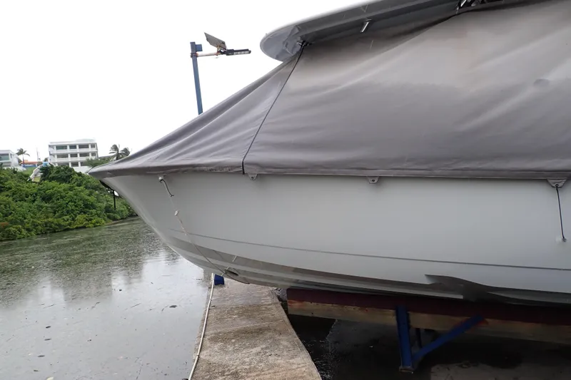 Archie Yacht Photos Pics 2021 Valhalla Boatworks V-33 covered, docked by a rainy waterfront.
