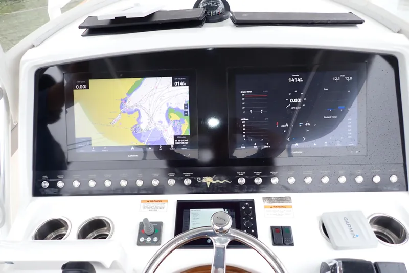 Archie Yacht Photos Pics 2021 Valhalla V-33 boat dashboard with dual Garmin displays and navigation controls.