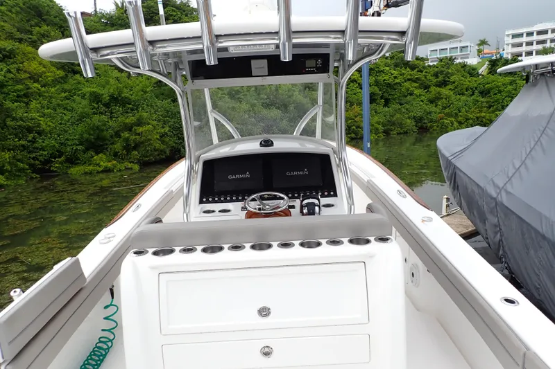 Archie Yacht Photos Pics 2021 Valhalla Boatworks V-33 with Garmin navigation, docked near lush greenery.