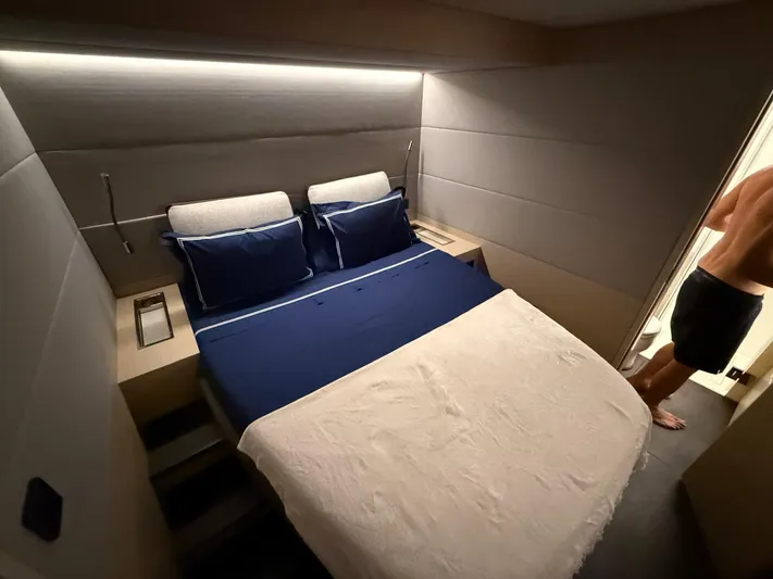 Jdmontt Yacht Photos Pics Luxurious bedroom interior of 2024 Lagoon 55 yacht with modern design and cozy bedding.